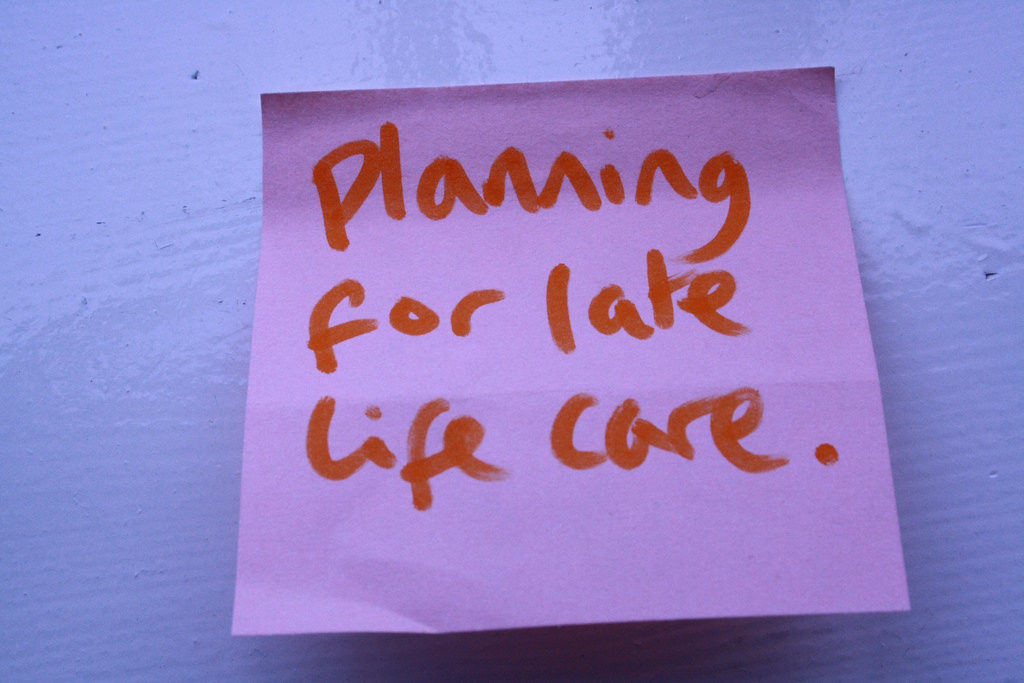 Pink post-it note reading, in handwritten marker, 'Planning for late life care.'